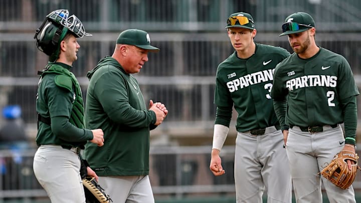 Michigan State's head coach Jake Boss Jr., center, talks to the team during a pitching change in the second inning on Wednesday, April 3, 2024, during the Crosstown Showdown against the Lugnuts at Jackson Field in Lansing.