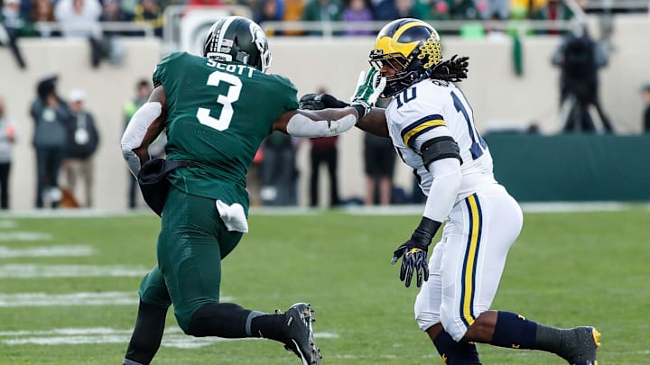 Michigan State running back LJ Scott runs against Michigan linebacker Devin Bush during the first half at Spartan Stadium on Saturday, Oct. 20, 2018.

10202018 Msu1sthalf 9