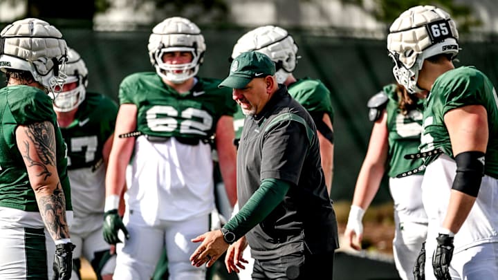 Michigan State offensive line coach Jim Michalczik, center, works with players during football practice on Tuesday, April 8, 2025, in East Lansing.