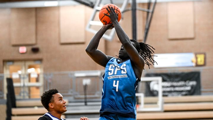 Team SPS and Michigan State's Kur Teng, right, scores as Team Case Credit Union and Michigan State's Nick Sanders defends during the Moneyball Pro-Am on Tuesday, June 24, 2025, at Holt High School. Team SPS and Michigan State's Kur Teng, right, scores as Team Case Credit Union and Michigan State's Nick Sanders defends during the Moneyball Pro-Am on Tuesday, June 24, 2025, at Holt High School.