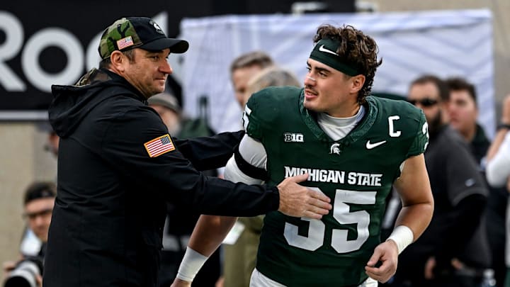 Michigan State senior Sam Edwards, right, is recognized by head coach Jonathan Smith during a ceremony before the game against Penn State on Saturday, Nov. 15, 2025, at Spartan Stadium in East Lansing. Michigan State senior Sam Edwards, right, is recognized by head coach Jonathan Smith during a ceremony before the game against Penn State on Saturday, Nov. 15, 2025, at Spartan Stadium in East Lansing.