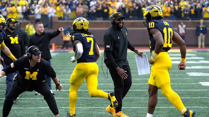 Michigan football coach Sherrone Moore celebrates a play with Michigan running back Donovan Edwards and Michigan quarterback Alex Orji during first-half action between Michigan and Minnesota at Michigan Stadium in Ann Arbor on Saturday, Sept. 28, 2024.