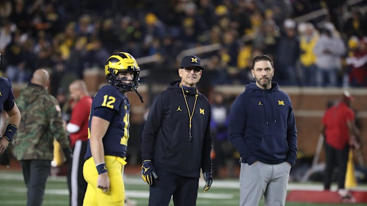 Michigan Wolverines head coach Jim Harbaugh, center, quarterbacks coach Matt Weiss, right, and quarterback Cade McNamara during warmups before action against the Indiana Hoosiers, Saturday, Nov. 6, 2021 at Michigan Stadium.