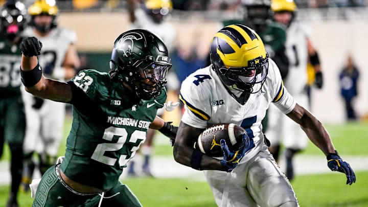 Michigan State's Darius Snow, left, tackles Michigan's Andrew Marsh during the third quarter on Saturday, Oct. 25, 2025, at Spartan Stadium in East Lansing.
