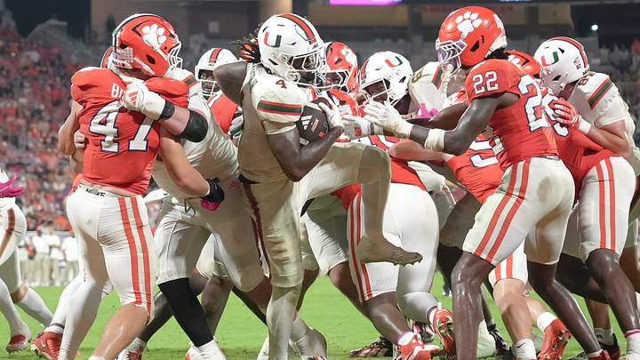Miami Hurricanes running back Mark Fletcher Jr. (4) dives over the top of Clemson players for a touchdown and lands on his feet, during the fourth quarter at Memorial Stadium Saturday, October 3, 2026.