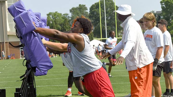 Seth Tillman, Class of 2027 defensive lineman from South Pointe High in Rock Hill, in a blocking drill with Clemson defensive ends coach Chris Rumph at the 2025 Dabo Swinney Football Camp in Clemson, S.C. Tuesday, June 3, 2025.