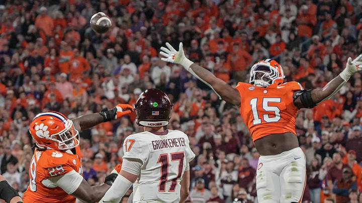 Virginia Tech Hokies quarterback Ethan Grunkemeyer (17) passes a ball despite pressure. Virginia Tech Hokies quarterback Ethan Grunkemeyer (17) passes a ball despite pressure.