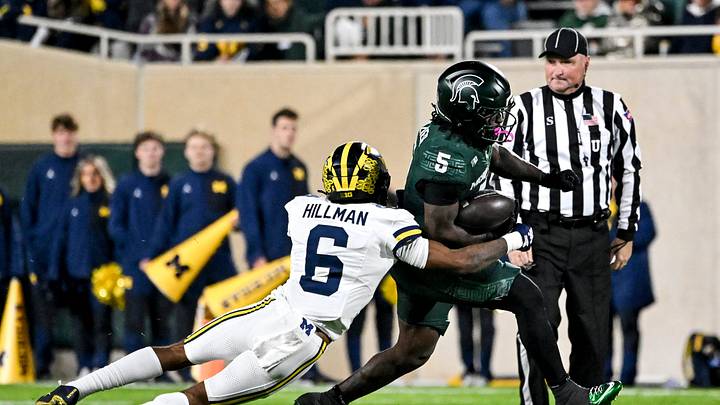 Michigan State's Makhi Frazier, right, attempts to evade Michigan's Brandyn Hillman during the second quarter on Saturday, Oct. 25, 2025, at Spartan Stadium in East Lansing, Mich. Michigan State's Makhi Frazier, right, attempts to evade Michigan's Brandyn Hillman during the second quarter on Saturday, Oct. 25, 2025, at Spartan Stadium in East Lansing, Mich.