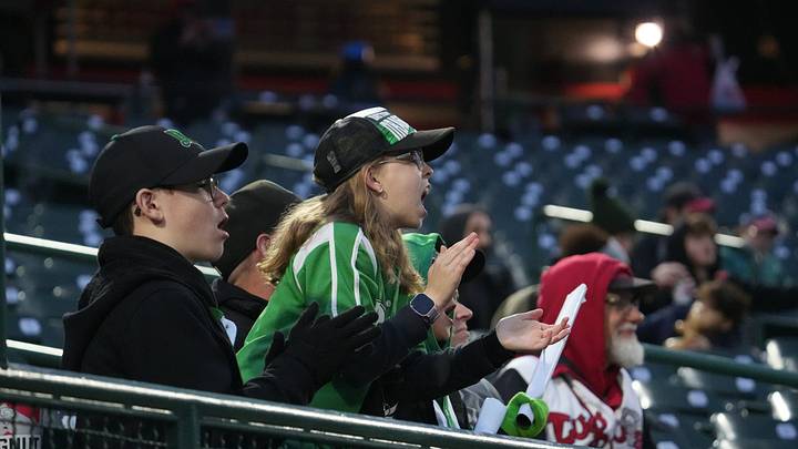 Dayton Dragons baseball fans cheer on their team against the Lansing Lugnuts, Thursday, April 2, 2026, during the season-opener at Jackson Field in Lansing. Dayton won 8-7. Dayton Dragons baseball fans cheer on their team against the Lansing Lugnuts, Thursday, April 2, 2026, during the season-opener at Jackson Field in Lansing. Dayton won 8-7.
