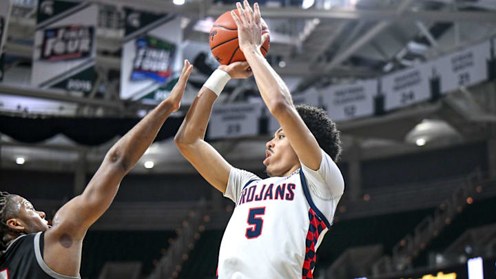 East Lansing's Cam Hutson, right, shoots as Orchard Lake St. Mary's Trey McKenney defends during the first quarter in the Division 1 state semifinal on Friday, March 14, 2025, at the Breslin Center in East Lansing.
