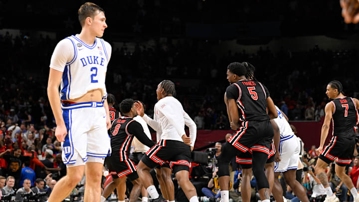 Flagg leaves the court as Houston players celebrate their comeback victory in the Final Four on Saturday in San Antonio.