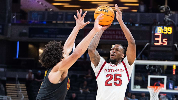 Mar 12, 2025; Indianapolis, IN, USA;  Rutgers Scarlet Knights guard Jeremiah Williams (25) shoots the ball while USC Trojans guard Desmond Claude (1) defends in the second half at Gainbridge Fieldhouse. Mandatory Credit: Trevor Ruszkowski-Imagn Images