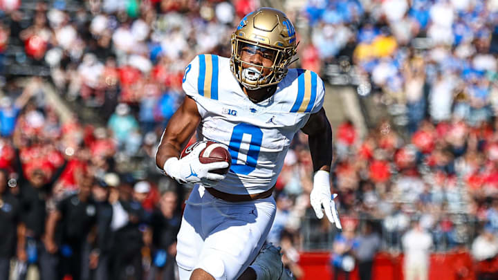 Oct 19, 2024; Piscataway, New Jersey, USA;  UCLA Bruins running back Jalen Berger (0) catches a pass for a touchdown as Rutgers Scarlet Knights linebacker Abram Wright (11) pursues during the second half at SHI Stadium. Mandatory Credit: Vincent Carchietta-Imagn Images