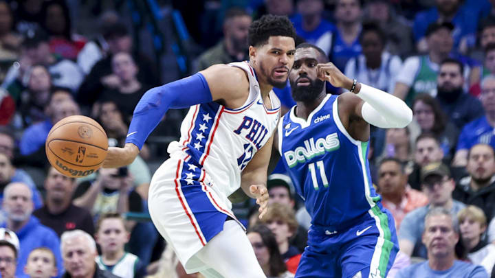 Mar 2, 2023; Dallas, Texas, USA; Philadelphia 76ers forward Tobias Harris (12) passes behind his back as Dallas Mavericks forward Tim Hardaway Jr. (11) watches during the second quarter at American Airlines Center. Mandatory Credit: Kevin Jairaj-Imagn Images Mar 2, 2023; Dallas, Texas, USA; Philadelphia 76ers forward Tobias Harris (12) passes behind his back as Dallas Mavericks forward Tim Hardaway Jr. (11) watches during the second quarter at American Airlines Center. Mandatory Credit: Kevin Jairaj-Imagn Images