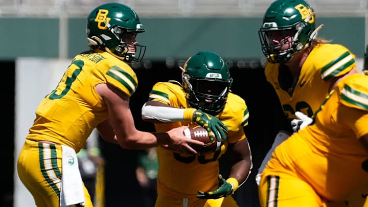 Sep 28, 2024; Waco, Texas, USA; Baylor Bears quarterback Sawyer Robertson (13) hands the ball off to Baylor Bears running back Bryson Washington (30) against the Brigham Young Cougars during the second half at McLane Stadium. Sep 28, 2024; Waco, Texas, USA; Baylor Bears quarterback Sawyer Robertson (13) hands the ball off to Baylor Bears running back Bryson Washington (30) against the Brigham Young Cougars during the second half at McLane Stadium.