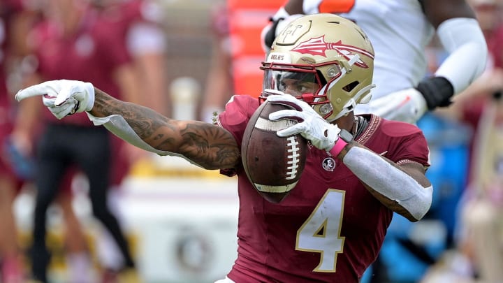 Oct 14, 2023; Tallahassee, Florida, USA; Florida State Seminoles wide receiver Keon Coleman (4) celebrates after catching a pass over Syracuse Orange defensive back Jason Simmons Jr. (6) (not pictured) during the first quarter at Doak S. Campbell Stadium. Mandatory Credit: Melina Myers-USA TODAY Sports Oct 14, 2023; Tallahassee, Florida, USA; Florida State Seminoles wide receiver Keon Coleman (4) celebrates after catching a pass over Syracuse Orange defensive back Jason Simmons Jr. (6) (not pictured) during the first quarter at Doak S. Campbell Stadium. Mandatory Credit: Melina Myers-USA TODAY Sports