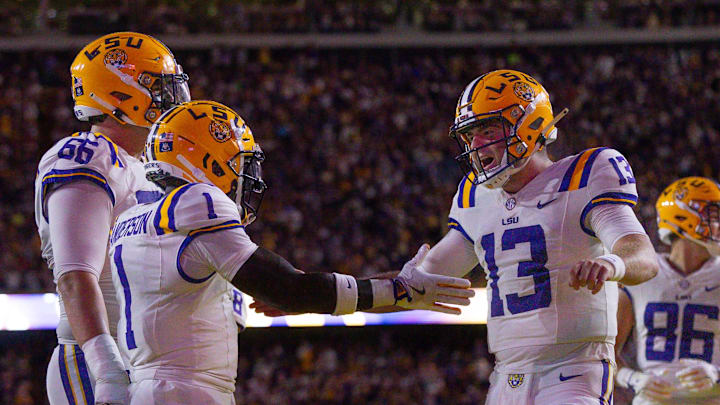 Sep 28, 2024; Baton Rouge, Louisiana, USA;  LSU Tigers wide receiver Aaron Anderson (1) celebrates a touchdown with quarterback Garrett Nussmeier (13) against the South Alabama Jaguars during the first quarter at Tiger Stadium. Mandatory Credit: Stephen Lew-Imagn Images
