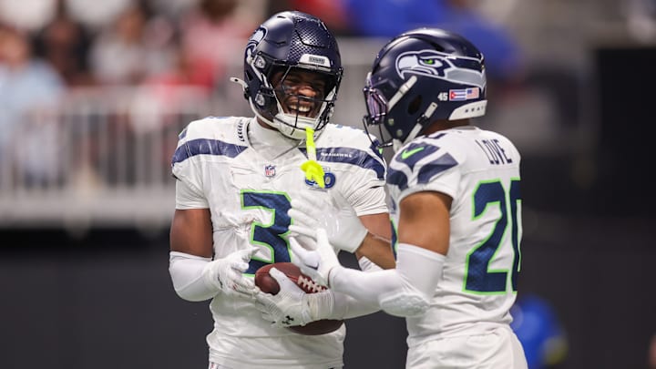 Nick Emmanwori (3) celebrates after an interception with safety Julian Love (20) against the Atlanta Falcons in the third quarter at Mercedes-Benz Stadium.