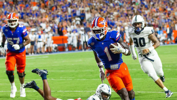 Samford Bulldogs safety Edwin Dearman (24) tries to chase down Florida Gators running back Montrell Johnson Jr. (1) as he scores a touch down during the first half at Ben Hill Griffin Stadium in Gainesville, FL on Saturday, September 7, 2024 against the Samford Bulldogs. The Gators lead 14-0 at the half. [Doug Engle/Gainesville Sun]