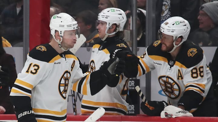 Mar 1, 2025; Pittsburgh, Pennsylvania, USA;  Boston Bruins right wing David Pastrnak (88) congratulates center Charlie Coyle (13) on an empty net goal against the Pittsburgh Penguins during the third period at PPG Paints Arena. Mandatory Credit: Charles LeClaire-Imagn Images