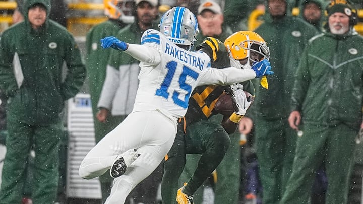 Detroit Lions cornerback Ennis Rakestraw Jr. (15) tackles Green Bay Packers wide receiver Jayden Reed (11) 