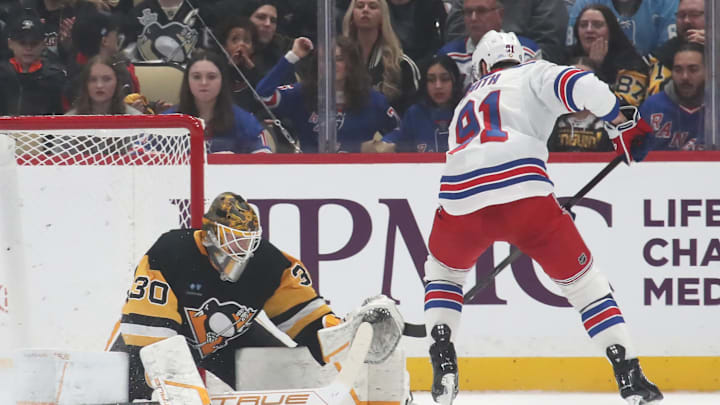 Feb 23, 2025; Pittsburgh, Pennsylvania, USA;  Pittsburgh Penguins goaltender Joel Blomqvist (30) makes a save  against New York Rangers right wing Reilly Smith (91) during the first period at PPG Paints Arena. Mandatory Credit: Charles LeClaire-Imagn Images