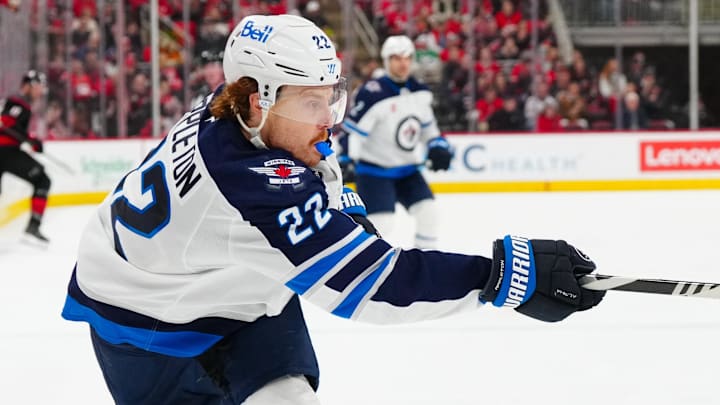 Mar 9, 2025; Raleigh, North Carolina, USA;  Winnipeg Jets center Mason Appleton (22) takes a shot against the Carolina Hurricanes during the second period at Lenovo Center. Mandatory Credit: James Guillory-Imagn Images