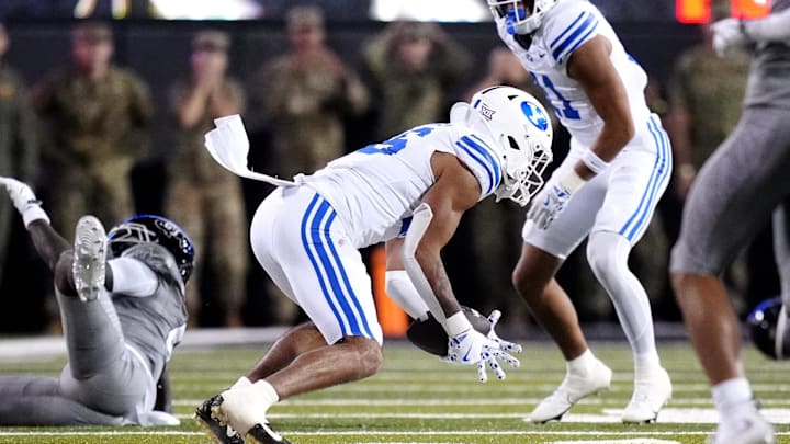 Sep 27, 2025; Boulder, Colorado, USA; Brigham Young Cougars linebacker Isaiah Glasker (16) pulls in an interception in the fourth quarter against the Colorado Buffaloes at Folsom Field. Mandatory Credit: Ron Chenoy-Imagn Images