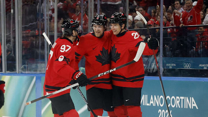 Feb 13, 2026; Milan, Italy; Thomas Harley of Canada celebrates with teammates after scoring their second goal  against Switzerland in men's ice hockey group A play during the Milano Cortina 2026 Olympic Winter Games at Milano Santagiulia Ice Hockey Arena. Mandatory Credit: Geoff Burke-Imagn Images