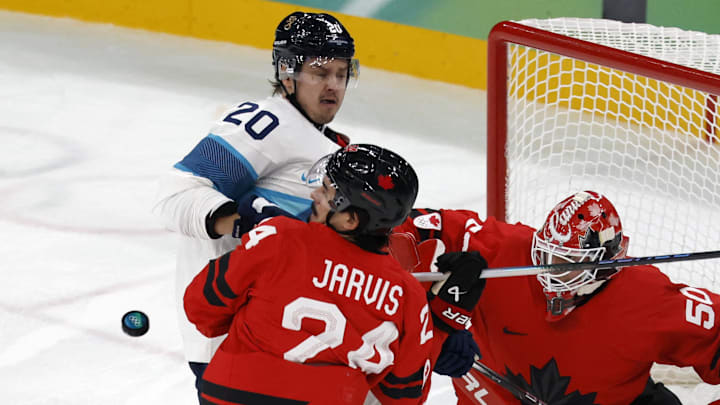 [US, Mexico & Canada customers only] Feb 20, 2026; Milan, Italy;  Sebastian Aho of Finland in action with Seth Jarvis of Canada and Jordan Binnington of Canada in a men's ice hockey semifinal during the Milano Cortina 2026 Olympic Winter Games at Milano Santagiulia Ice Hockey Arena. Mandatory Credit: David W Cerny/Reuters via Imagn Images