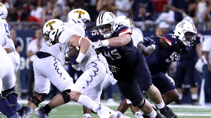Sep 2, 2023; Tucson, Arizona, USA; Arizona Wildcats defensive lineman Bill Norton (45) tackles Northern Arizona Lumberjacks running back TJ McDaniel (1) during the second half at Arizona Stadium. Mandatory Credit: Zac BonDurant-USA TODAY Sports
