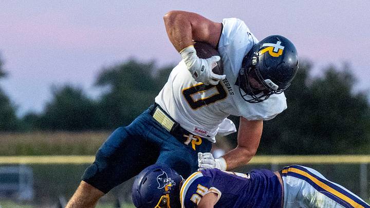 Regina’s Tate Wallace (0) is tackled by Alburnett’s Laken Caves (24) during a high school football game Sept. 10, 2026 in Alburnett, Iowa.