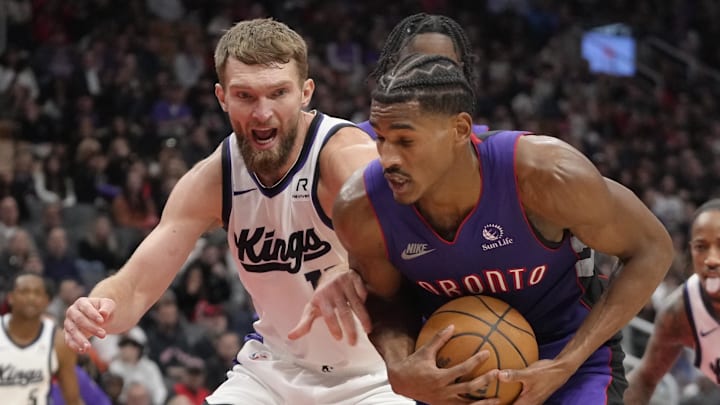 Nov 2, 2024; Toronto, Ontario, CAN; Sacramento Kings forward Domantas Sabonis (11) and Toronto Raptors guard Ochai Agbaji (30) battle for the ball during the second half at Scotiabank Arena. Mandatory Credit: John E. Sokolowski-Imagn Images