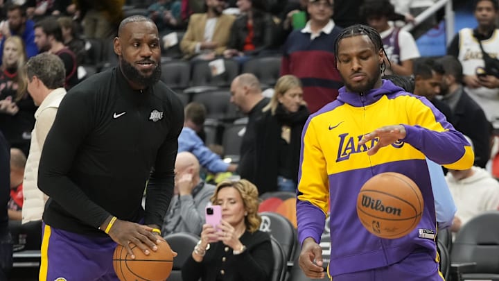 LeBron James (left) watches son Bronny James (right) warm-up before the start of the game against the Toronto Raptors at Scotiabank Arena. LeBron James (left) watches son Bronny James (right) warm-up before the start of the game against the Toronto Raptors at Scotiabank Arena.