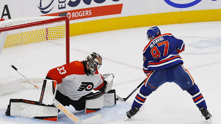 Philadelphia Flyers goaltender Samuel Ersson (33) makes a save on Edmonton Oilers forward Connor McDavid (97)