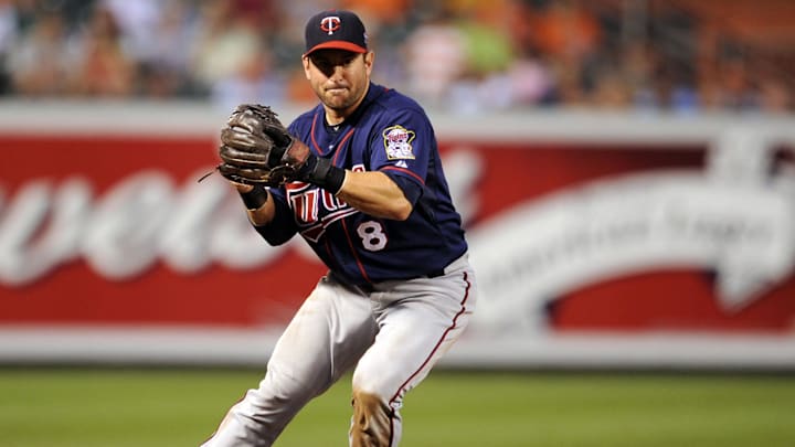 Minnesota Twins third baseman Nick Punto fields a ground ball against the Baltimore Orioles at Oriole Park at Camden Yards in 2010.