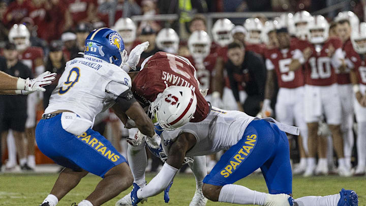 Sep 27, 2025; Stanford, California, USA;  Stanford Cardinal wide receiver CJ Williams (3) gets tackled by San Jose State Spartans linebacker Noah McNeal-Franklin (9) and linebacker Jordan Pollard (1) during the fourth quarter at Stanford Stadium. Mandatory Credit: Stan Szeto-Imagn Images

