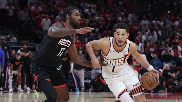 Jan 5, 2026; Houston, Texas, USA; Phoenix Suns guard Devin Booker (1) dribbles against Houston Rockets forward Tari Eason (17) in the second half  at Toyota Center. Mandatory Credit: Thomas Shea-Imagn Images