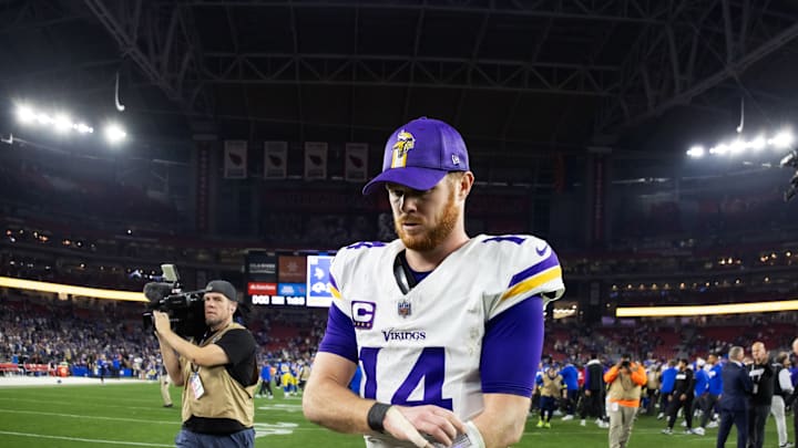 Jan 13, 2025; Glendale, AZ, USA; Minnesota Vikings quarterback Sam Darnold (14) reacts as he walks off the field after losing to the Los Angeles Rams during an NFC wild card game at State Farm Stadium.