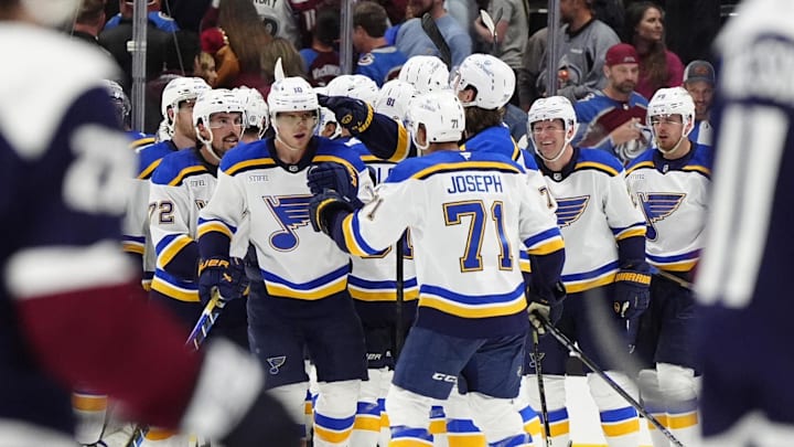 Mar 29, 2025; Denver, Colorado, USA; Members of the St. Louis Blues celebrate defeating the Colorado Avalanche at Ball Arena. Mandatory Credit: Ron Chenoy-Imagn Images