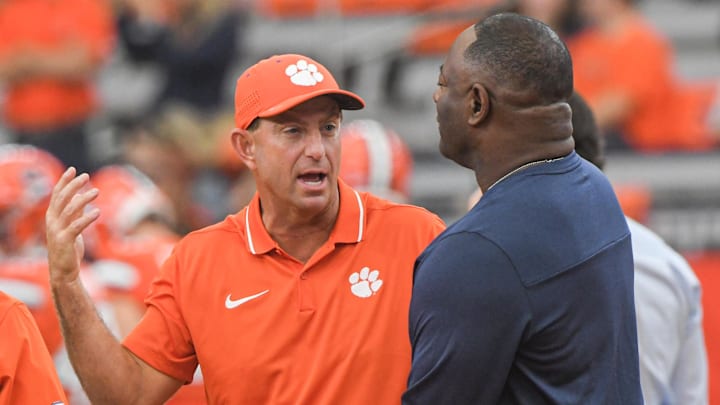 Sep 30, 2023; Syracuse, New York, USA; Clemson head coach Dabo Swinney and Syracuse Head Football Coach Dino Babers  talk before the game at JMA Wireless Dome. Mandatory Credit: Ken Ruinard-Imagn Images

