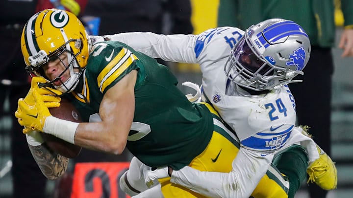 Green Bay Packers wide receiver Christian Watson (9) is tackled by Detroit Lions cornerback Amani Oruwariye.