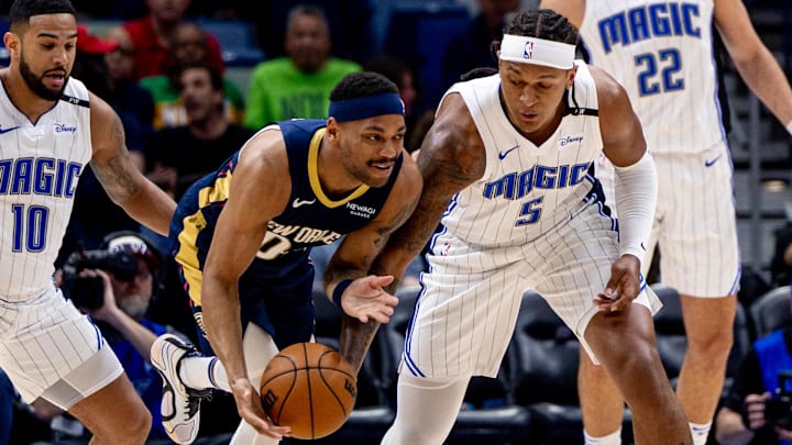 New Orleans Pelicans forward Bruce Brown (00) dribbles against Orlando Magic forward Paolo Banchero (5) during the first half at Smoothie King Center.