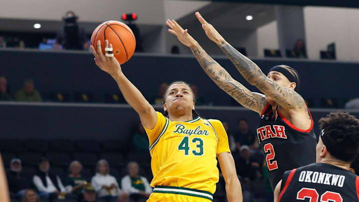 Mar 7, 2026; Waco, Texas, USA;  Baylor Bears guard Cameron Carr (43) scores a layup as Utah Utes guard Terrence Brown (2) defends during the first half at Paul and Alejandra Foster Pavilion. Mandatory Credit: Chris Jones-Imagn Images
