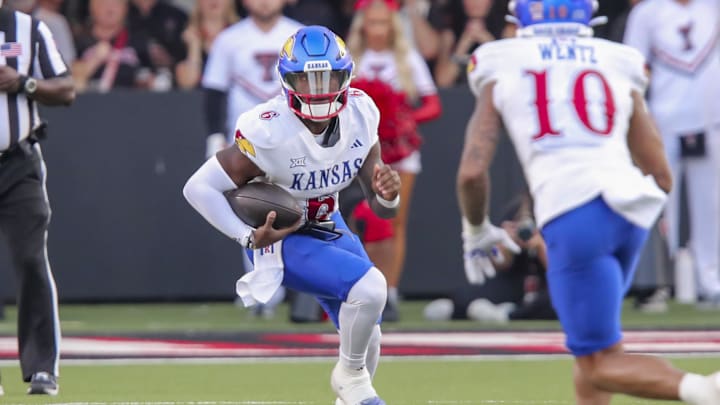 Oct 11, 2025; Lubbock, Texas, USA;  Kansas Jayhawks quarterback Jalon Daniels (6) scrambles against the Texas Tech Red Raiders in the first half at Jones AT&T Stadium. Mandatory Credit: Michael C. Johnson-Imagn Images