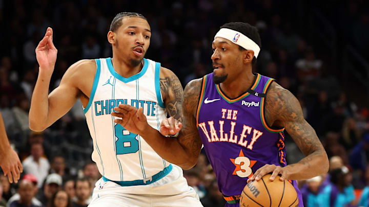 Jan 12, 2025; Phoenix, Arizona, USA; Phoenix Suns guard Bradley Beal (3) dribbles the ball past Charlotte Hornets guard Nick Smith Jr. (8) during the first half at Footprint Center. Mandatory Credit: Mark J. Rebilas-Imagn Images
