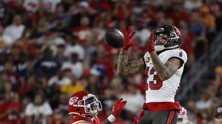 Oct 2, 2022; Tampa, Florida, USA; Tampa Bay Buccaneers wide receiver Mike Evans (13) catches the ball over Kansas City Chiefs cornerback Jaylen Watson (35) during the second half at Raymond James Stadium. Mandatory Credit: Kim Klement-Imagn Images