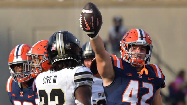 Oct 12, 2024; Champaign, Illinois, USA;  Illinois Fighting Illini linebacker Luke Zardzin (42) recovers a fumble in the first half against the Purdue Boilermakers at Memorial Stadium. Mandatory Credit: Ron Johnson-Imagn Images