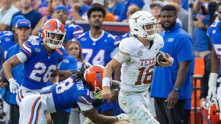 Texas quarterback Arch Manning (16) evades Florida defensive back Bryce Thornton (18) during the second half an NCAA football game in Gainesville, FL on Saturday, October 4, 2025. [Alan Youngblood/Gainesville Sun]