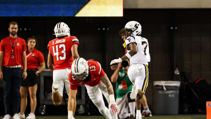 Oct 26, 2024; Tucson, Arizona, USA;  West Virginia Mountaineers wide receiver Traylon Ray (7) looks back as he runs with the ball and scores a touchdown during the fourth quarter against the Arizona Wildcats at Arizona Stadium. Mandatory Credit: Aryanna Frank-Imagn Images